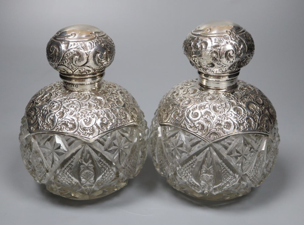 A pair of Edwardian repousse silver-mounted globular glass scent bottles, J.H. Worrel, Son & Co Ltd, Birmingham, 1907